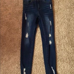 Blue jeans with some ripped Holes in it